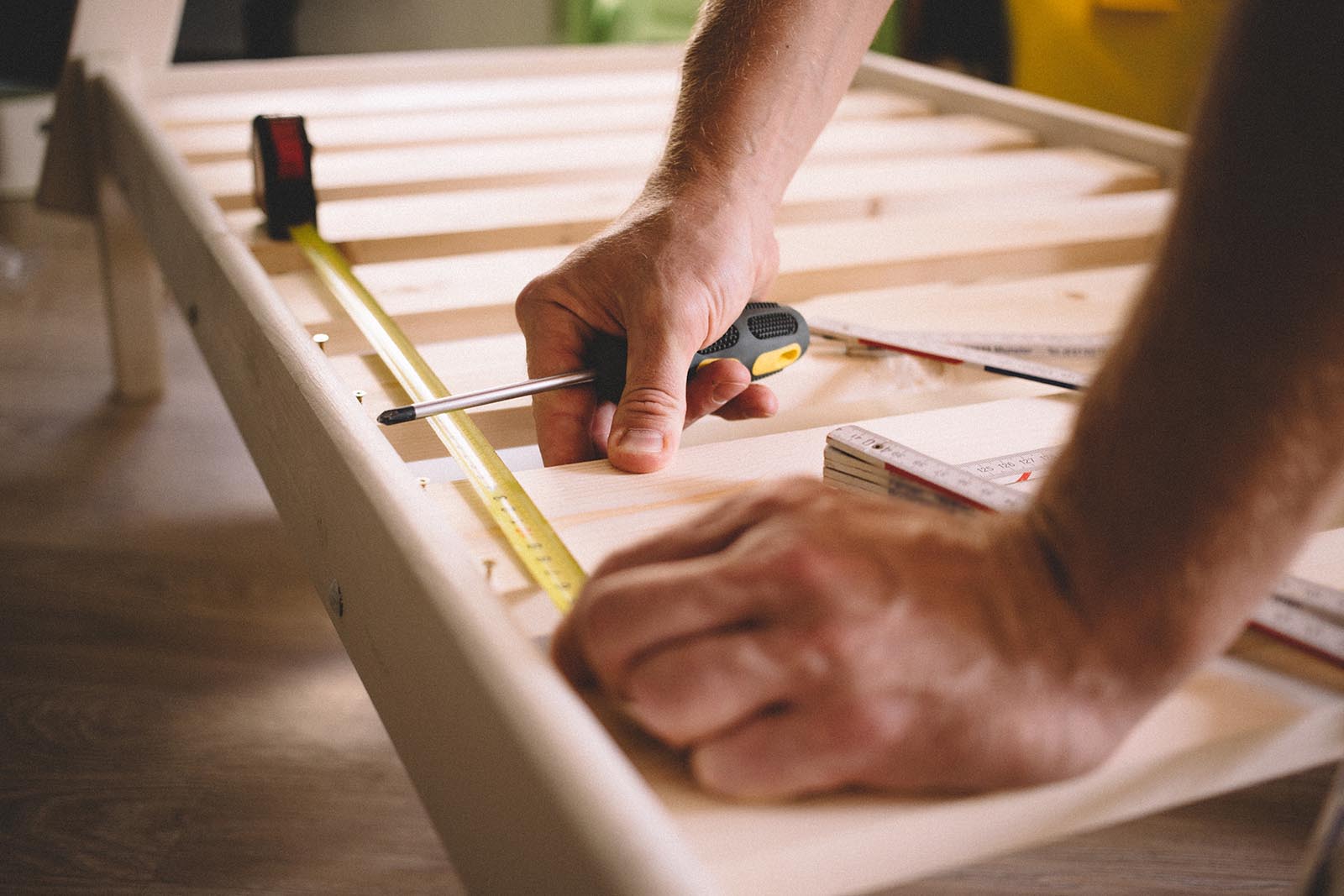 close up hands of a man, a man screws a screwdriver, instruction and construction roulette, self-Assembly of furniture